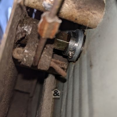 Inside view of a garage door lock connecting to the door and locking mechanism