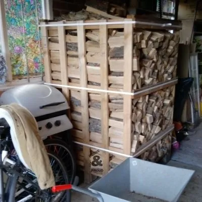 Oak logs in a wooden crate in a garage