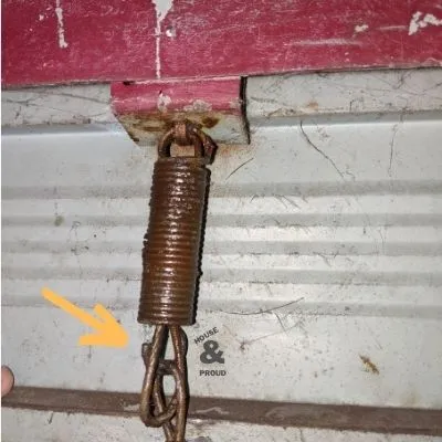 Spring locking mechanism on a garage door
