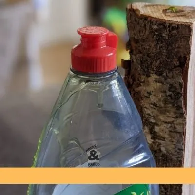 Picture of washing up liquid next to log