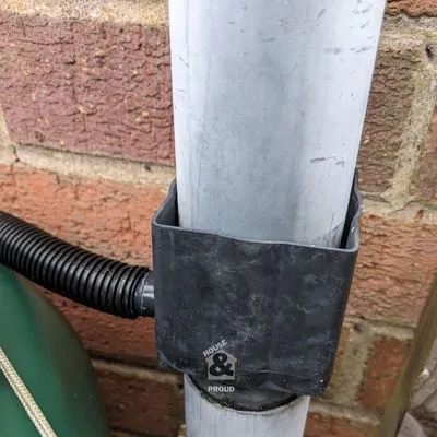 Flexible hose connecting to garden water barrel