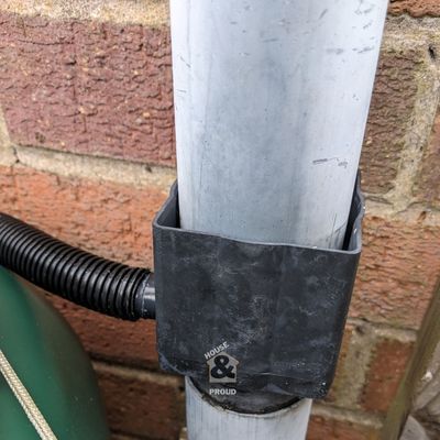 Flexible hose connecting to garden water barrel